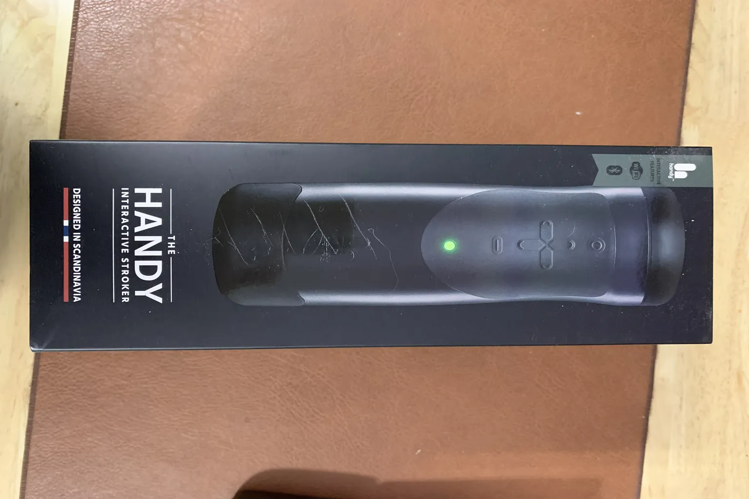 Boîte officielle The Handy avec visuel du stimulateur interactif et voyant vert